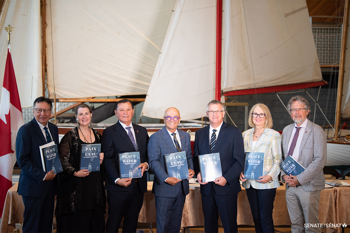 Senators Dan Christmas, Marilou McPhedran, Brian Francis, René Cormier, Fabian Manning, Jane Cordy and Stan Kutcher hold copies of the Senate Committee on Fisheries and Oceans’ report after the press conference at the Maritime Museum of the Atlantic in Halifax.