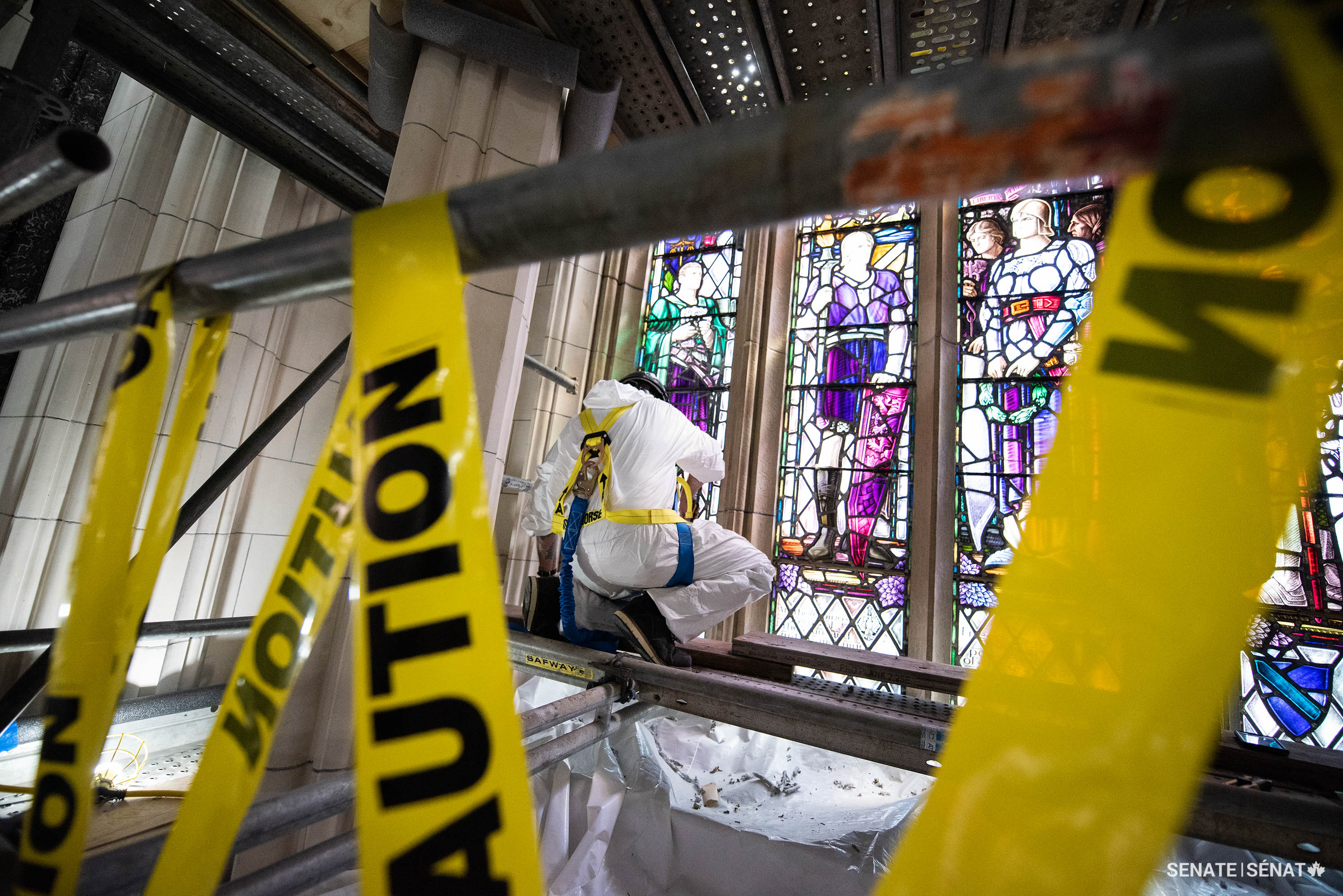 Workers delicately remove a section of The Assembly of Remembrance from the Memorial Chamber in Centre Block.