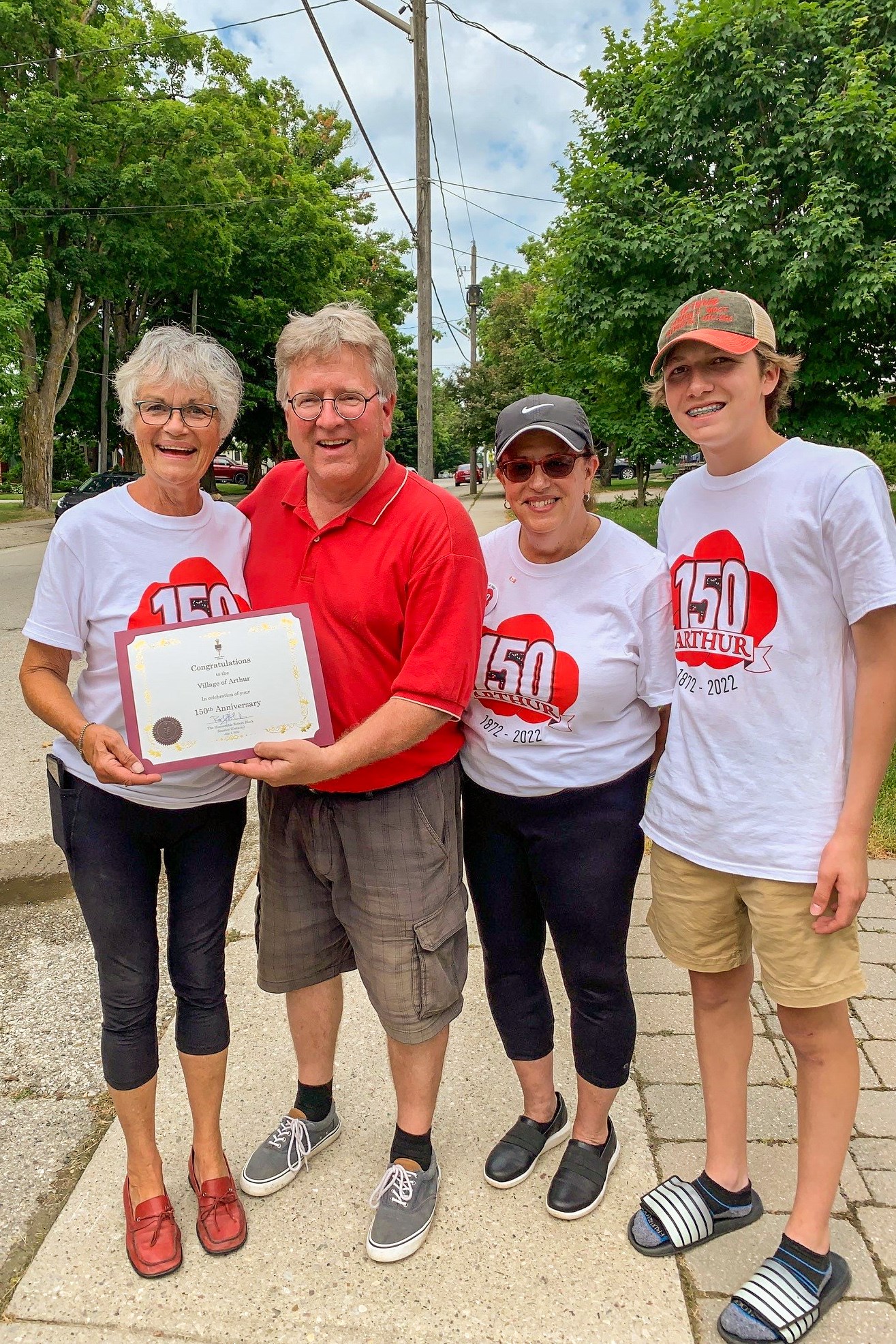 Friday, July 1, 2022 – Senator Rob Black presents a certificate of congratulations to Faye Craig, chair of the committee that planned the 150th anniversary celebrations for the community of Arthur in Wellington County, Ontario.