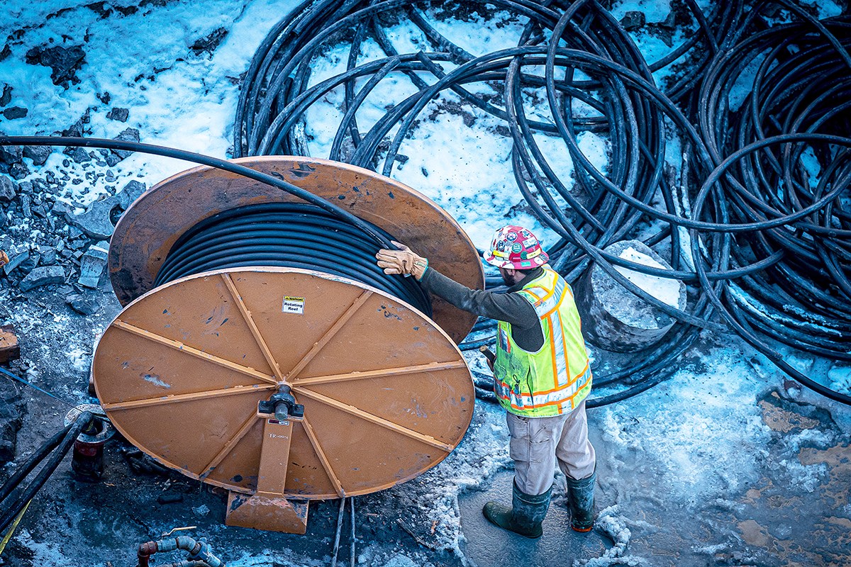 Hundreds of metres of polyethylene pipe are fed into the borehole from large spools. (Photo credit: Public Services and Procurement Canada)