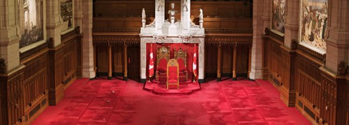 The Senate Chamber in Centre Block, with all senators’ desks removed and the crimson carpet exposed.