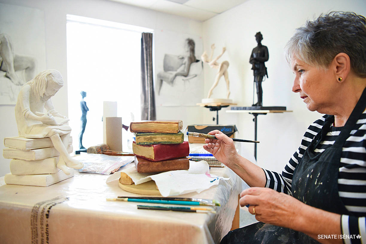 Ms. Breault-Landry puts the finishing touches on a recent piece.