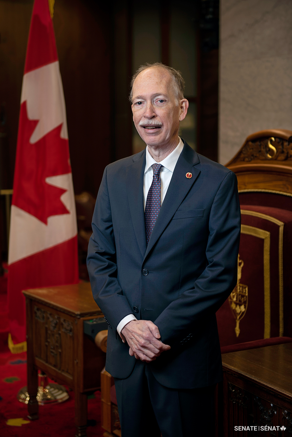 Senator Shugart stands in front of the Speaker’s chair in the Senate Chamber.