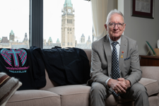 Senator Boisvenu sitting on a sofa in his office on Parliament Hill.