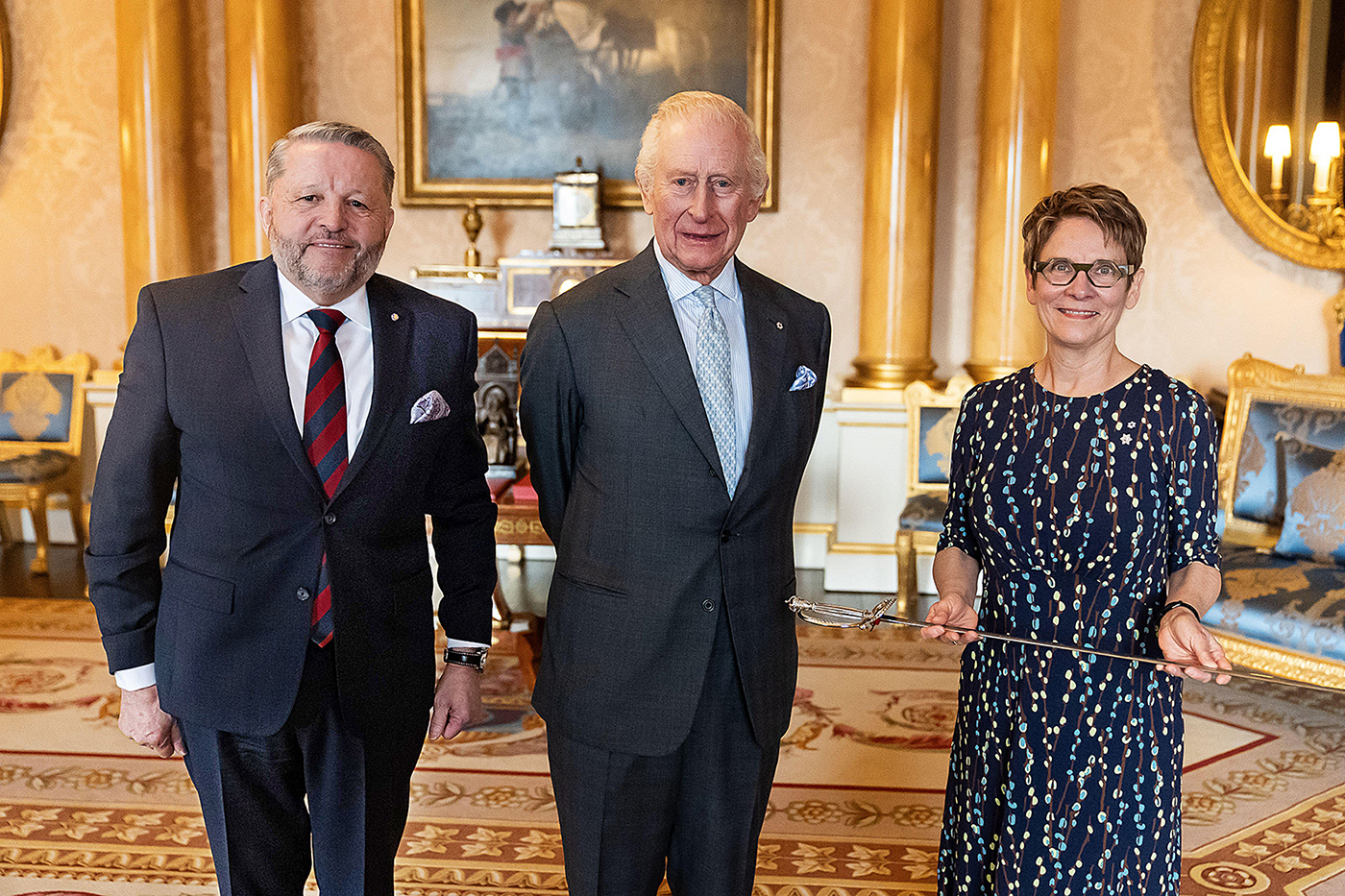 Speaker of the Senate Raymonde Gagné, right, holds the new sword at Buckingham Palace next to King Charles III and Usher of the Black Rod J. Greg Peters. (Photo credit: PA Media)