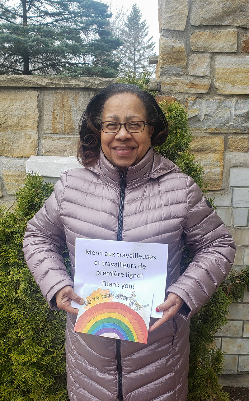 Senator Mégie holds up a message of support for essential front-line workers during the COVID-19 pandemic. She later sponsored a bill, which was passed, designating March 11 as Pandemic Observance Day. (Photo credit: Office of Senator Marie-Françoise Mégie)