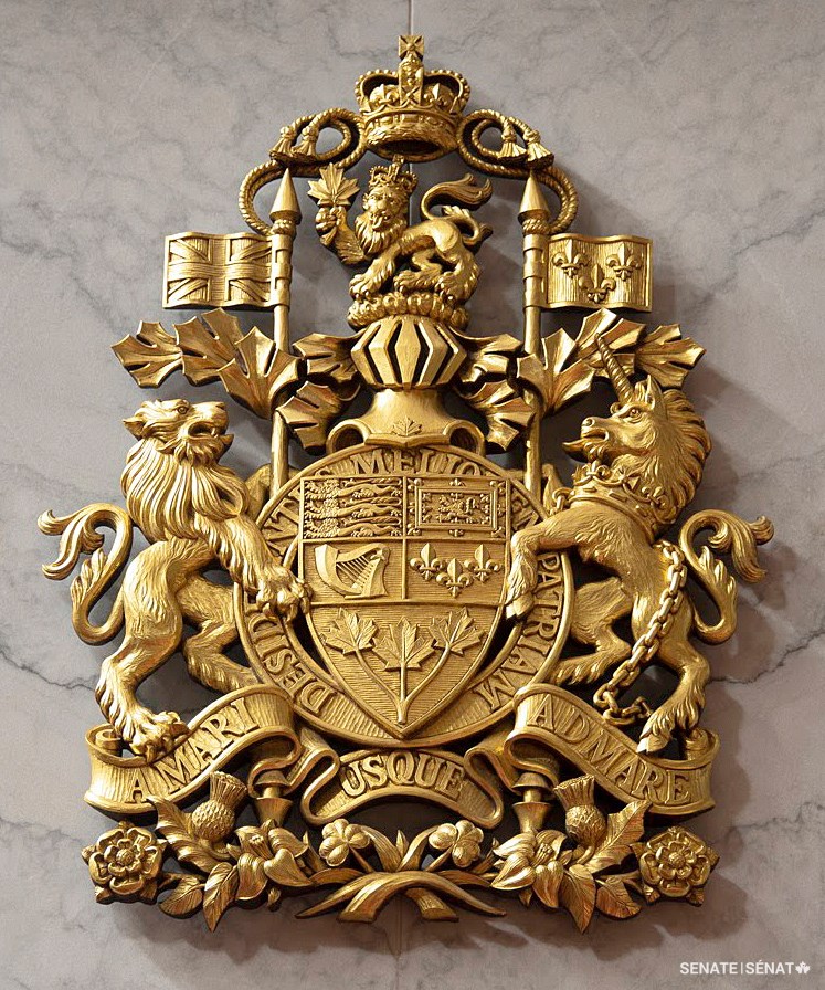 The lion and the unicorn in their familiar roles as supporters of the shield in the Arms of Canada. This sculpture hangs in the Red Chamber in the Senate of Canada Building.
