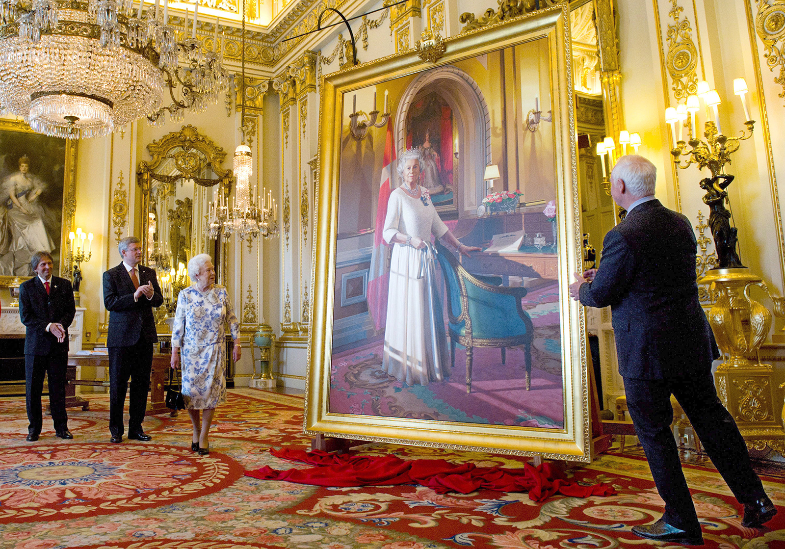The portrait was unveiled on June 6, 2012, in the White Drawing Room at Buckingham Palace. In attendance were, from left, Mr. Richards, Prime Minister Stephen Harper, the Queen and Governor General David Johnston.