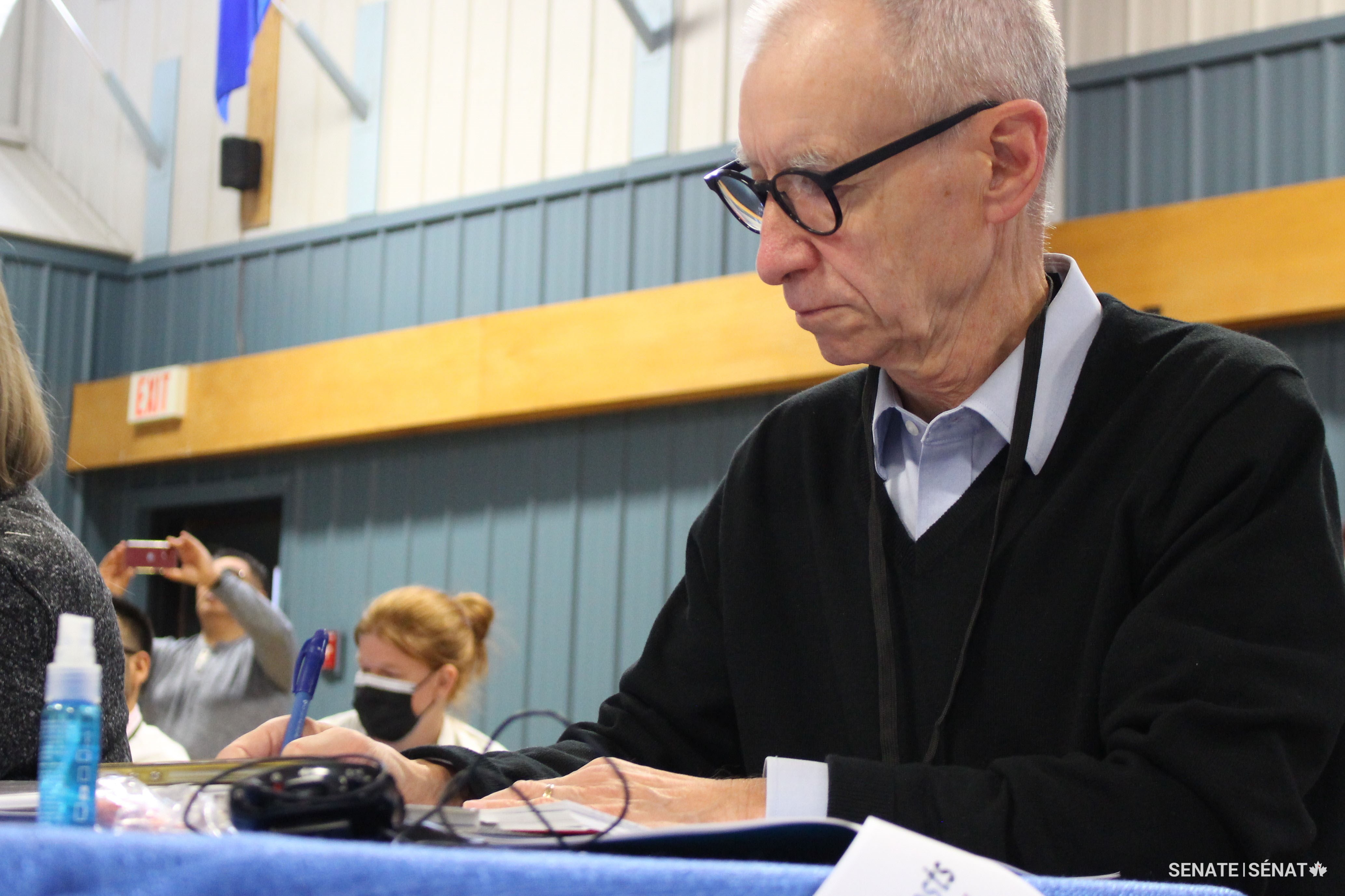 Senator Tony Dean, chair of the Senate Committee on National Security, Defence and Veterans Affairs, takes notes during the Arctic Sovereignty and Security Summit in Iqaluit, hosted by Senator Dennis Patterson.