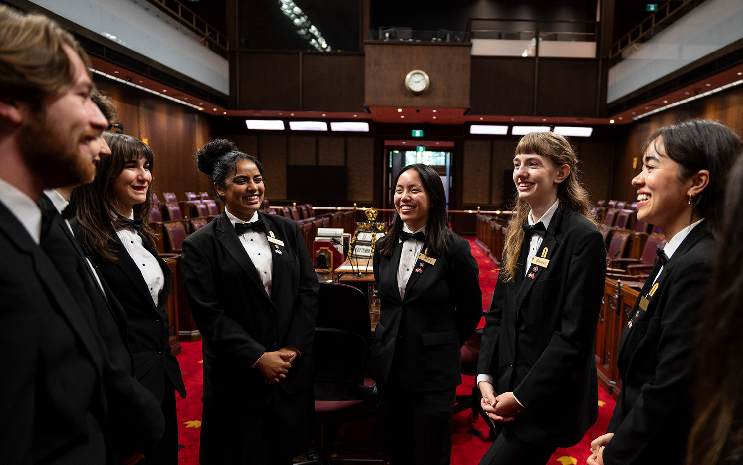 Senate pages talking amongst themselves in the Senate Chamber.