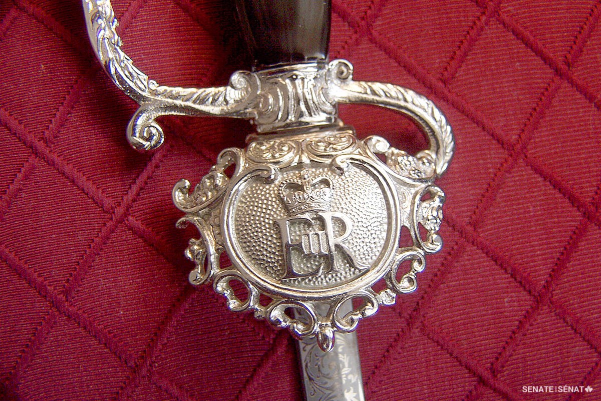 Queen Elizabeth’s royal cypher appears on the guard of the Usher of the Black Rod’s silver dress sword, where the blade and hilt meet.