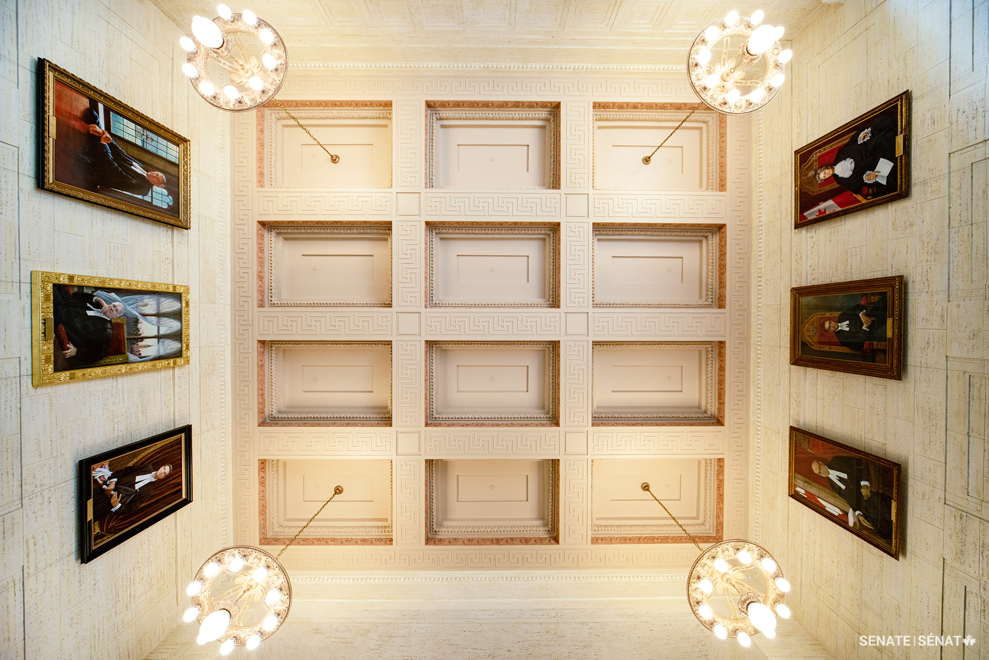 Official portraits of former Senate Speakers hang over the grand staircase connecting the entrance and foyer of the Senate of Canada Building.