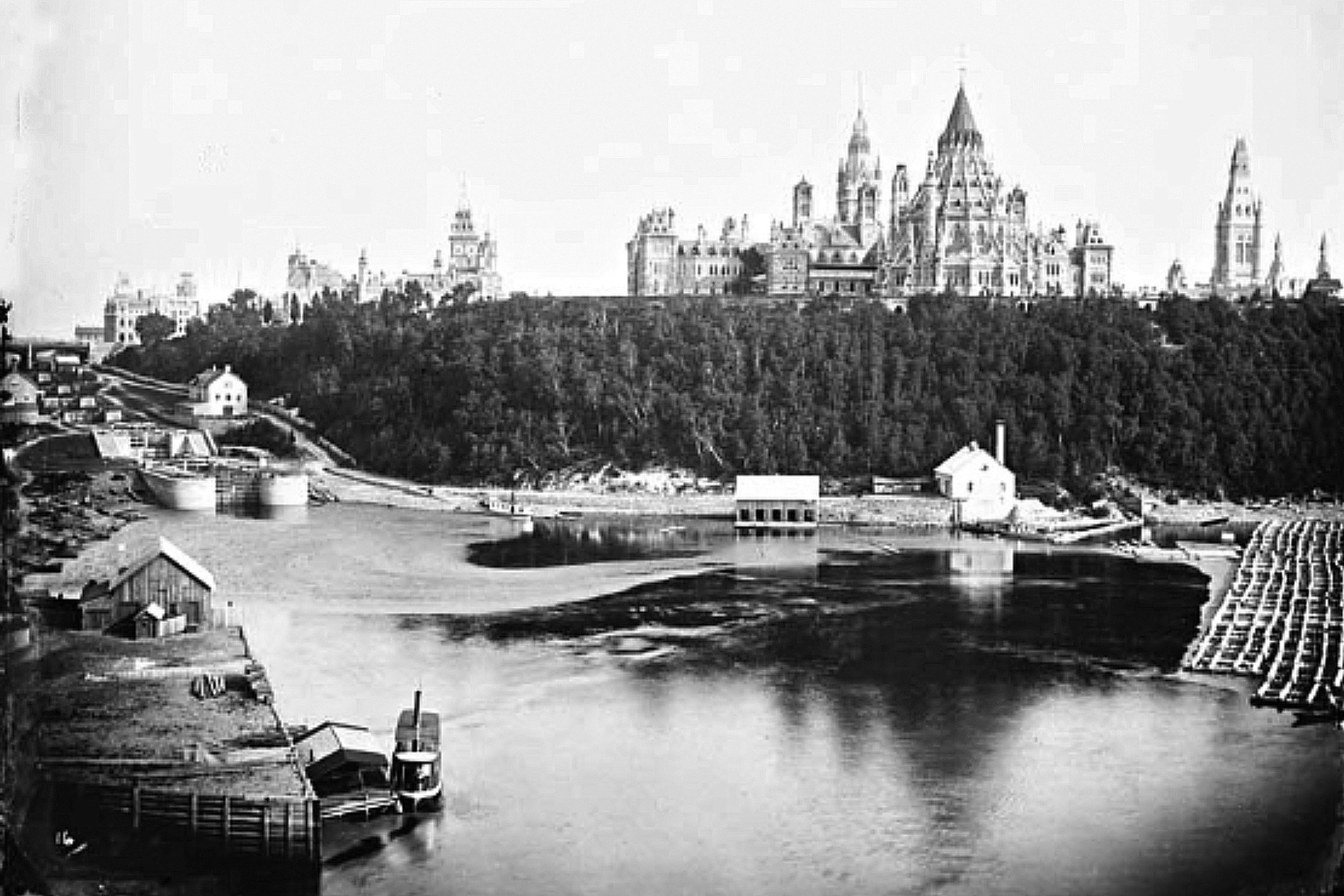 The Parliament Building was designed to showcase its dramatic setting. Symmetrical and stately on the side facing the city, the structure was a fantasy-realm jumble of towers, spires and buttresses on the side facing the river. (Photo credit: Library and Archives Canada)