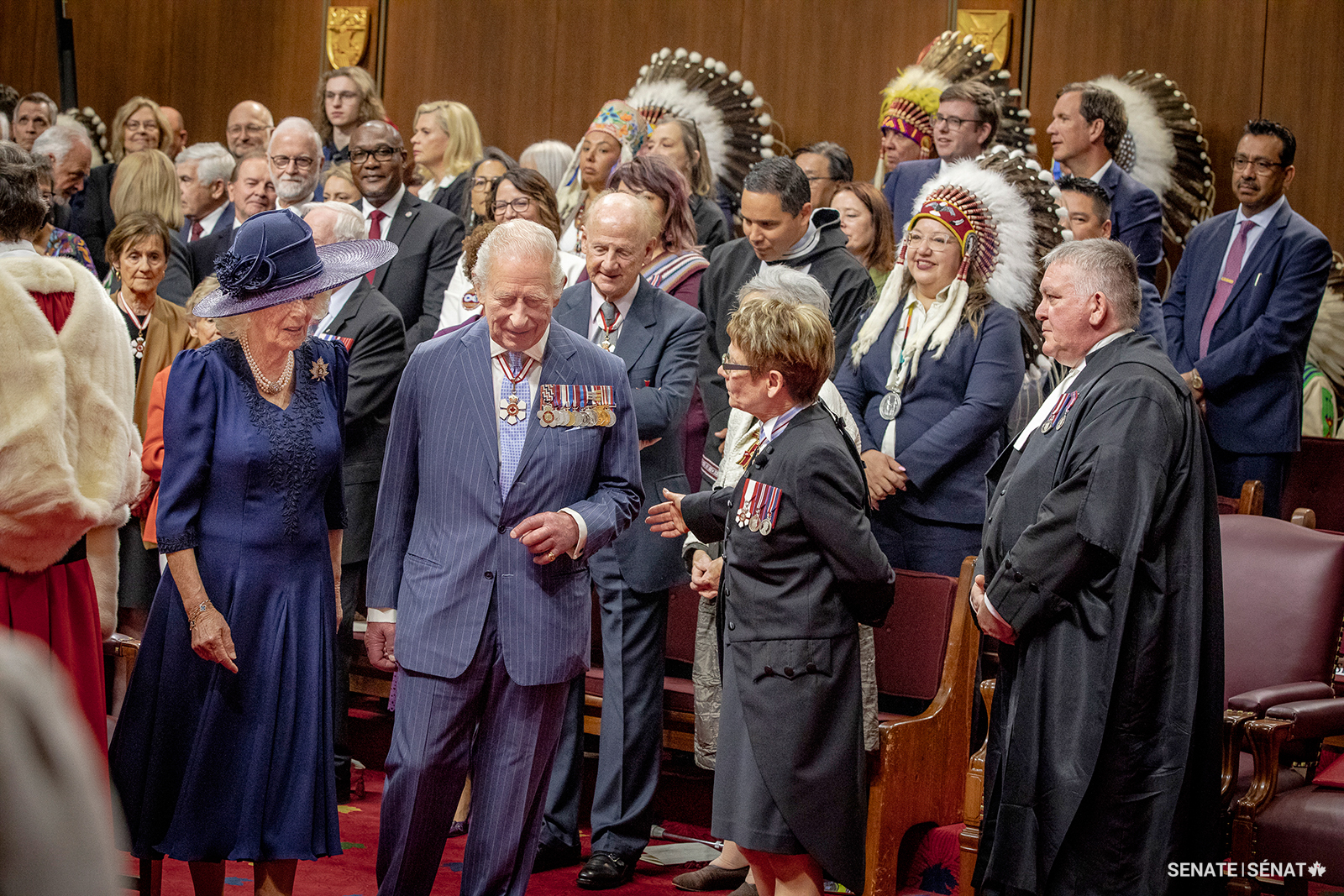 Speaker Gagné presents senators and other dignitaries to the King while awaiting members of the House of Commons before the throne speech. To accommodate the number of people who wanted to attend, all of the senators’ desks were removed and replaced with benches for what is called a bench opening.