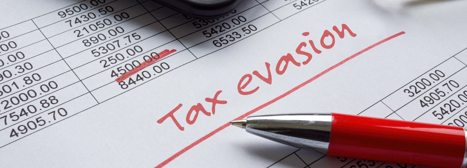 The words “tax evasion” written in red pen on a financial document.