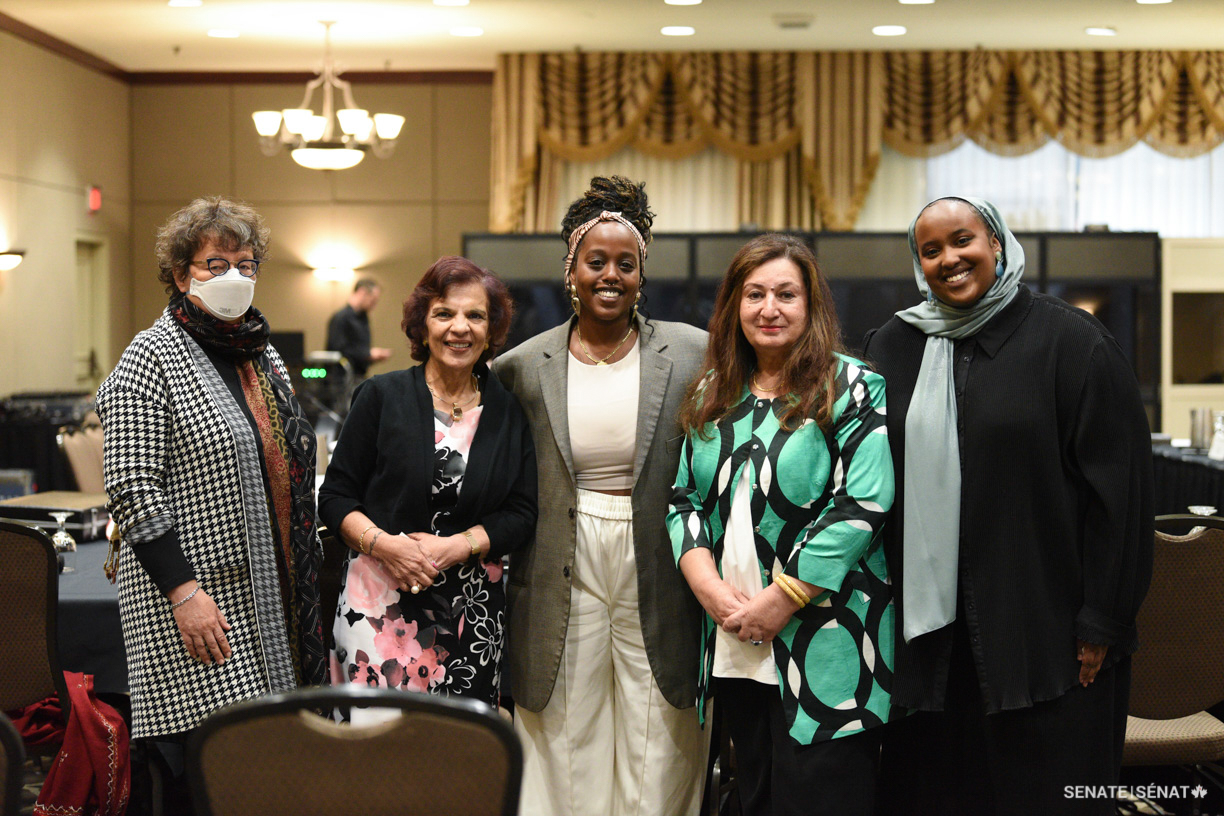 Black Art Matters Director, poet and queer activist Nasra Adem, centre, and poet Timiro Mohamed, right, pose for a picture with, from left, senators Paula Simons, Mobina S. B. Jaffer and Salma Ataullahjan at a public hearing in downtown Edmonton on Thursday, September 8, 2022.