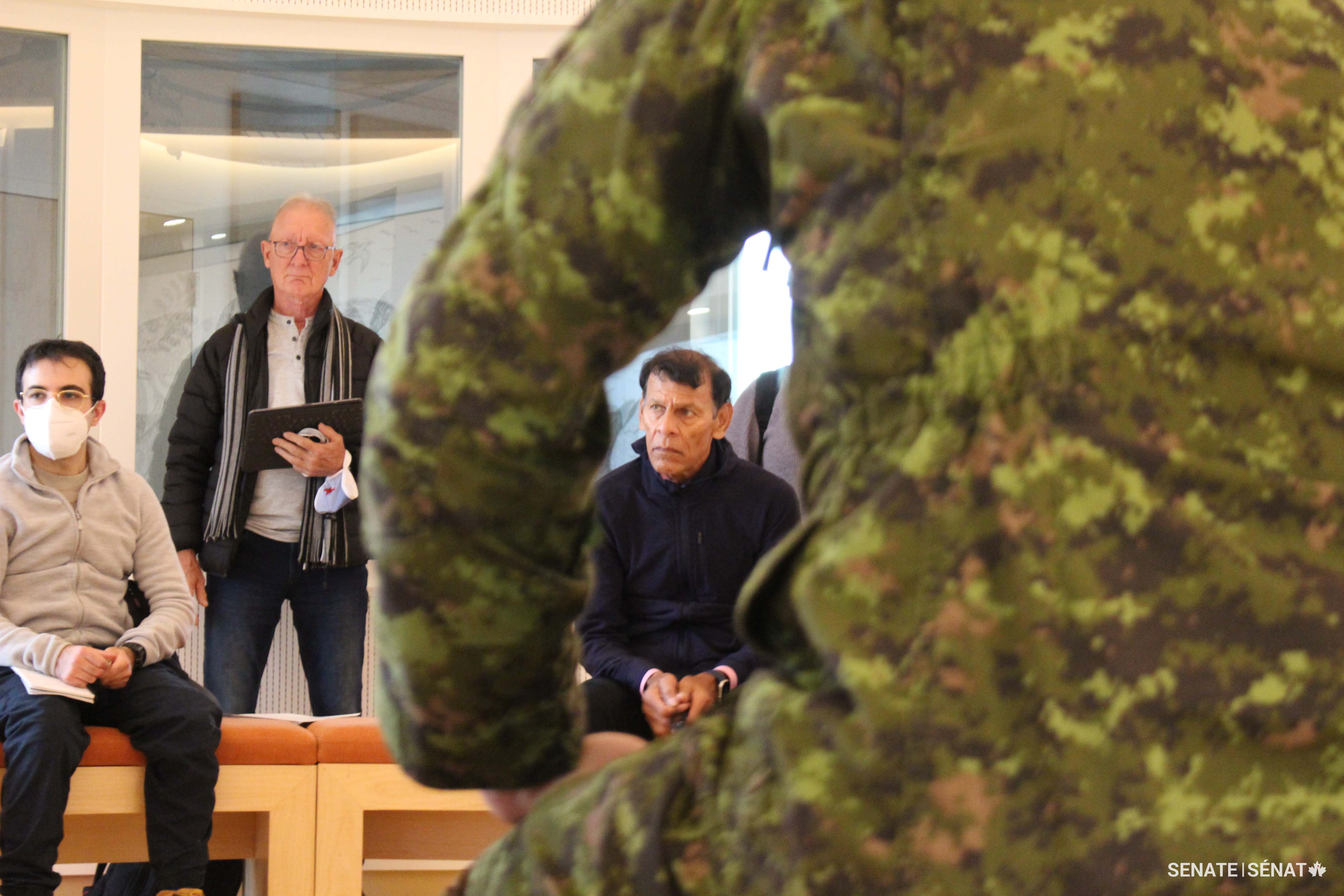 Senators Boisvenu and Yussuff listen to a presentation from Canadian Rangers at the Canadian High Arctic Research Station in Cambridge Bay. Rangers are lightly equipped and self-sufficient — and they serve loyally despite a history of forced relocation that saw Inuit summarily dispatched to the High Arctic in the name of Canadian sovereignty.