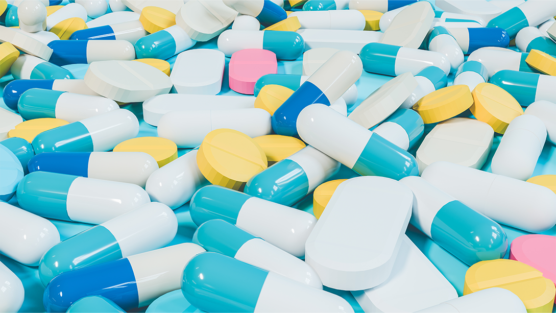 A pile of colouful pharmaceutical pills and capsules of various shapes and sizes.