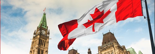 A Canada flag waves in the wind outside of Parliament Hill in Ottawa.