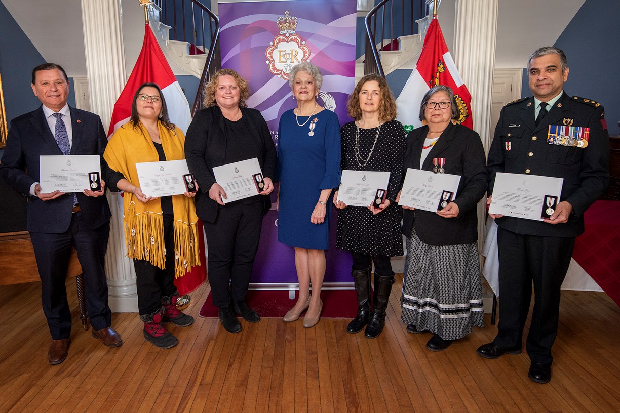 Senator Brian Francis, left, joins Prince Edward Island Lieutenant Governor Antoinette Perry, centre, during a Queen Elizabeth II Platinum Jubilee Medal presentation ceremony. The senator and five Islanders, whom he nominated, received the medals for their outstanding contributions to the province.