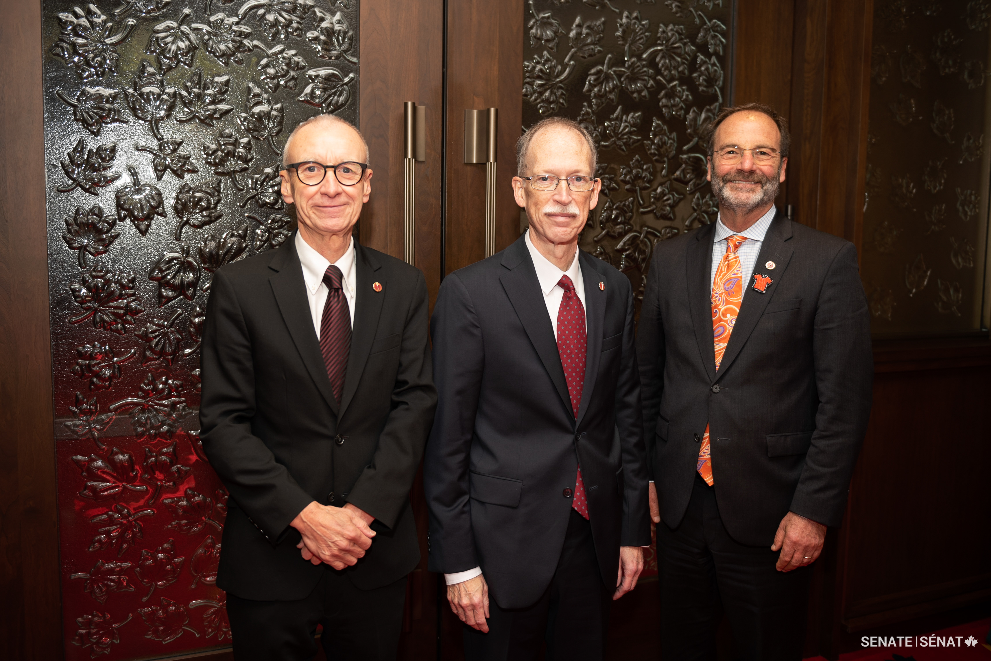 Senator Ian Shugart, centre, outside the Senate Chamber before he is sworn in as a senator on September 29, 2022. Also pictured are senators Tony Dean, left, and Marc Gold.