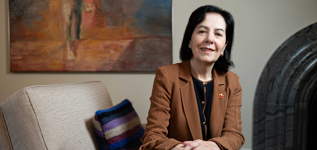 A woman sits in her office.