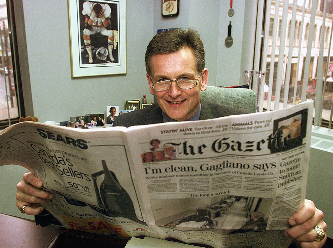 Senator Smith holds up a copy of what was then The Gazette after being named the newspaper’s publisher in January 2002. (Photo credit: CP PHOTO/Ryan Remiorz)