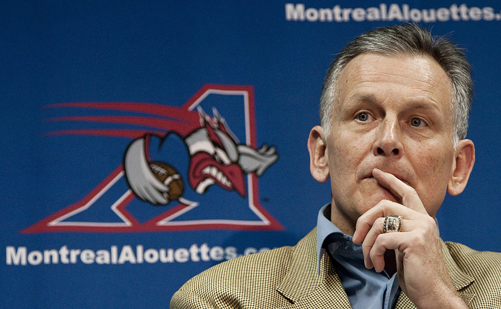 Senator Smith, then president and CEO of the Montreal Alouettes, takes questions from reporters after announcing that he will be leaving the CFL club at a Montréal news conference in November 2010. (Photo credit: THE CANADIAN PRESS/Paul Chiasson)