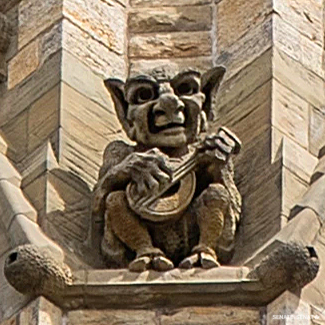 Grotesques playing musical instruments perch along a ledge halfway up the tower. They allude to the carillon housed inside.
