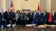 Twelve senators representing regions in Atlantic Canada stand in a line, smiling at the camera.