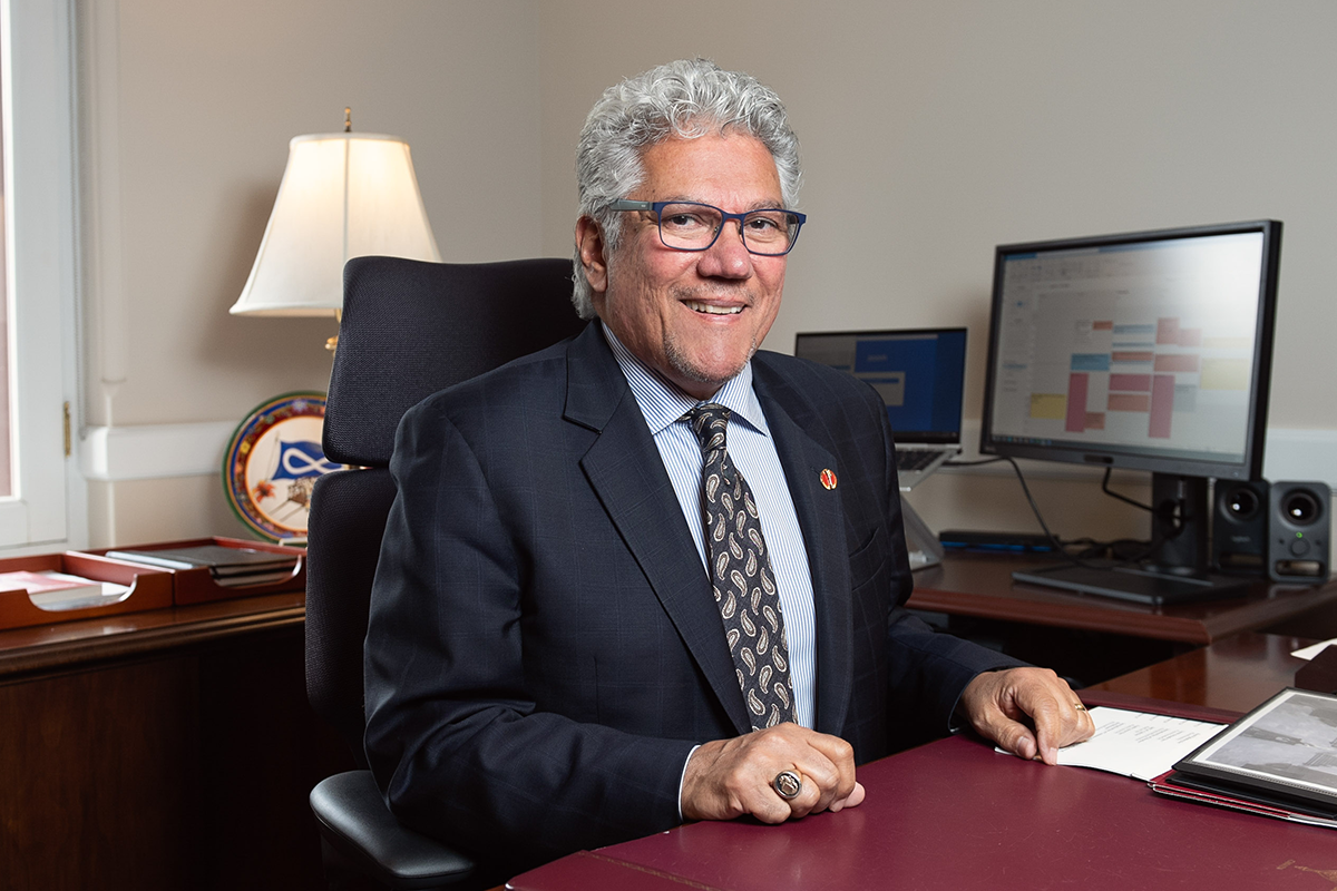 Senator Marty Klyne sits at a desk in his office.