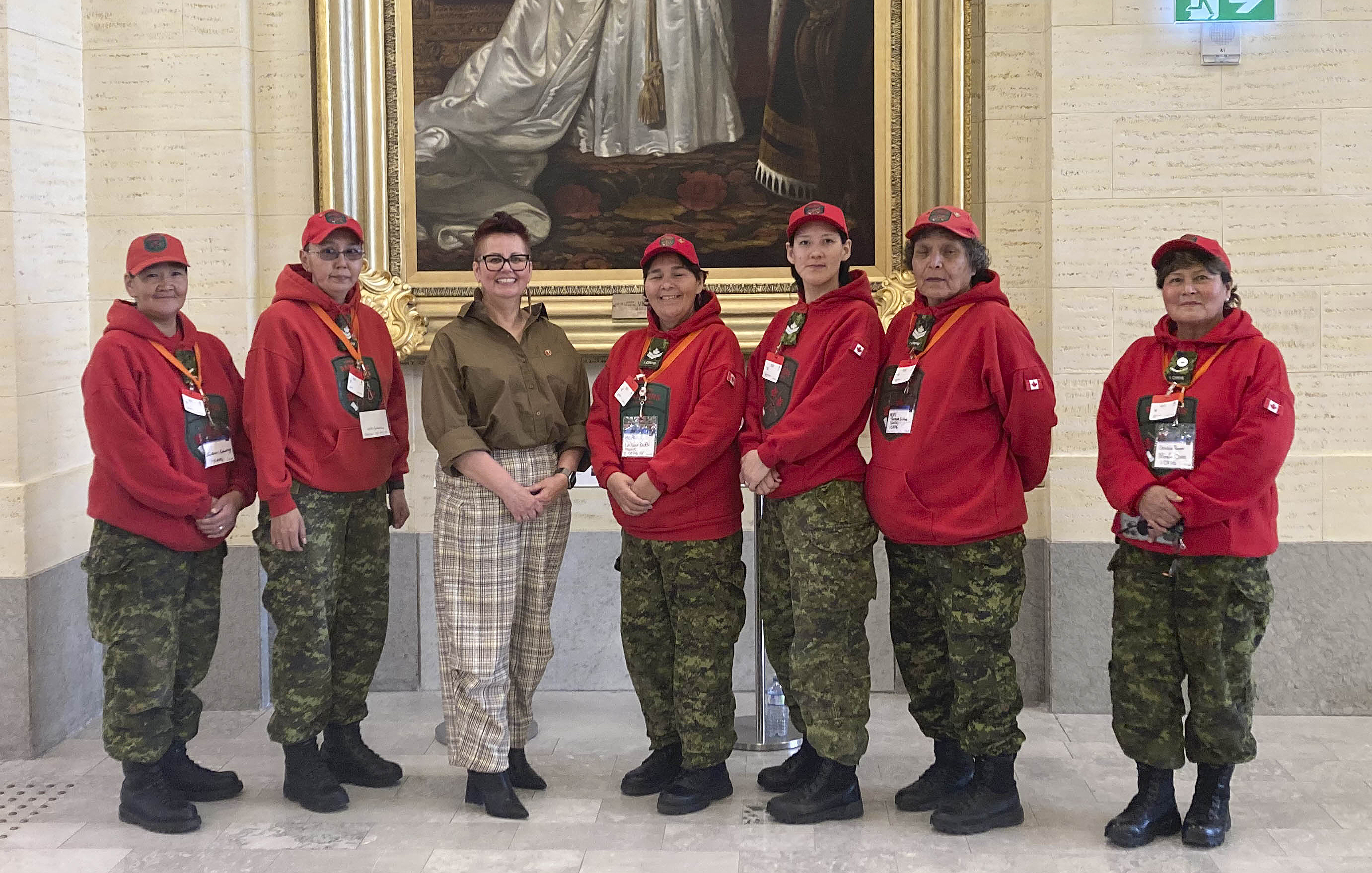 A group of people stand in the Senate of Canada building.