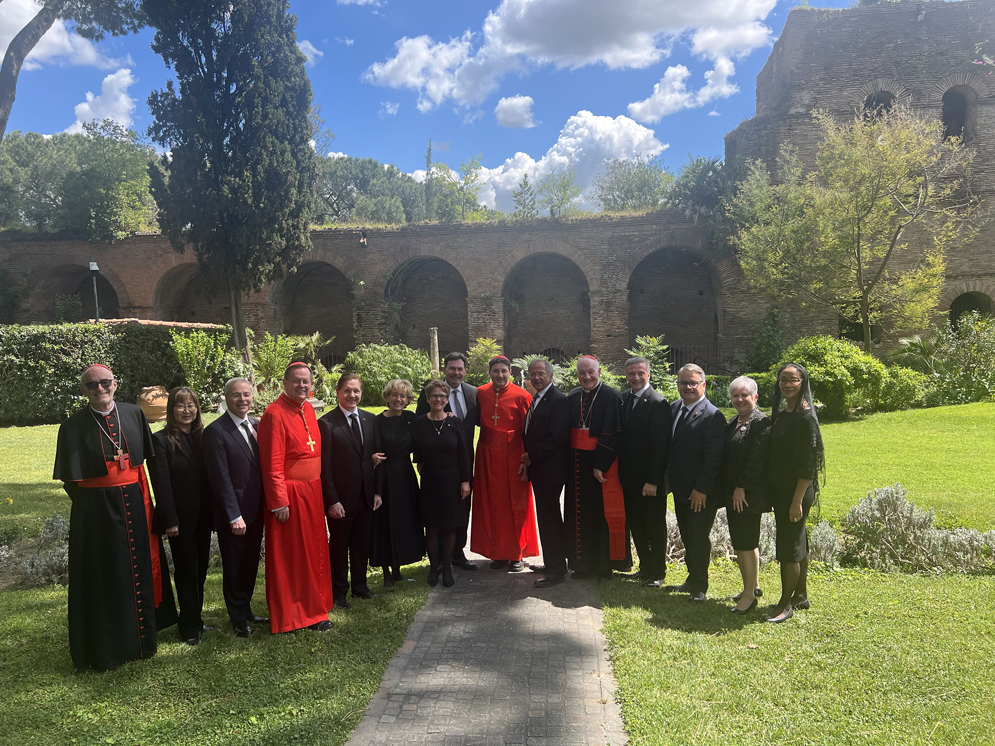 A group of dignitaries in formal and religious attire pose for a photo in Vatican City, Rome, Italy.