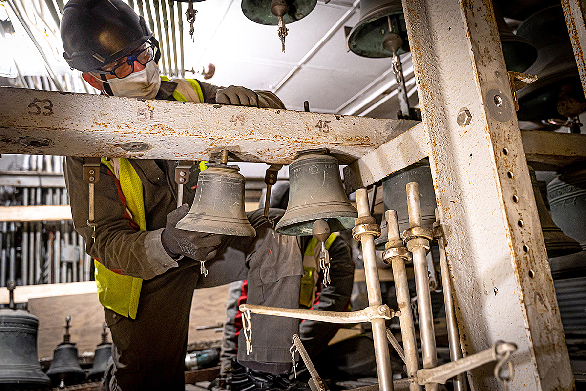 A technician removes one of the carillon’s small bells for inspection. The 17 smallest will be outfitted with entirely new clappers. (Photo credit: Public Services and Procurement Canada)