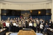 A group of people standing in front of a podium.
