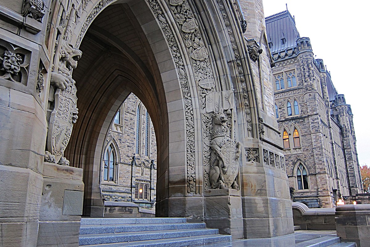 Dominion Sculptor Cleóphas Soucy and his assistant, Coeur de Lion McCarthy, carved the lion and unicorn statues flanking Centre Block’s Peace Tower entrance in 1937. (Photo credit: Wikimedia Commons)