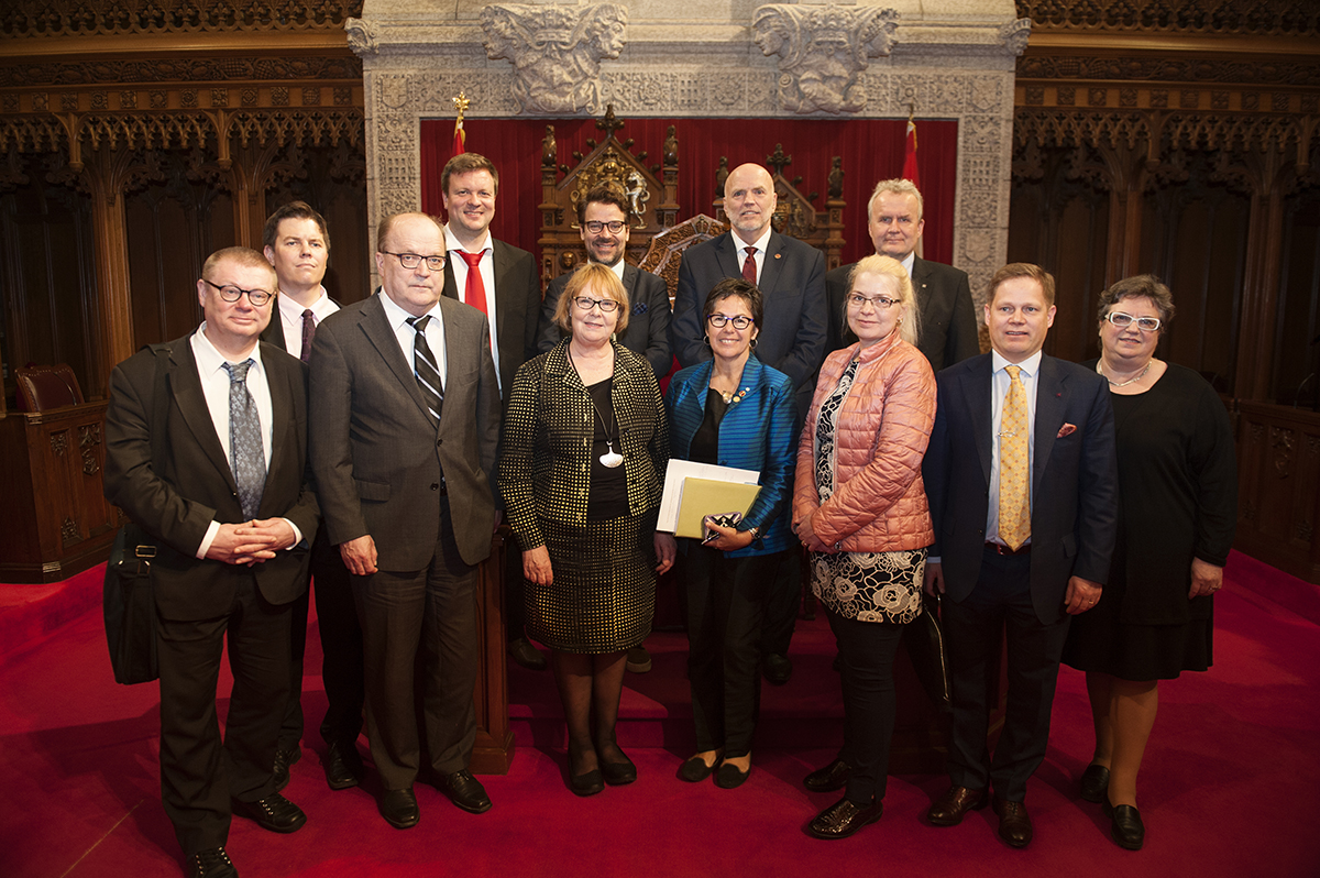 Senator White (back row, second from right) poses with members of the Constitutional Law Committee from the Parliament of Finland in the Red Chamber in Centre Block in 2017. Also pictured is Senator Kim Pate (front row, middle).