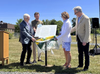 A group of four people unveil the first Canadian Literary Trail Bookmark plaque in New Brunswick.