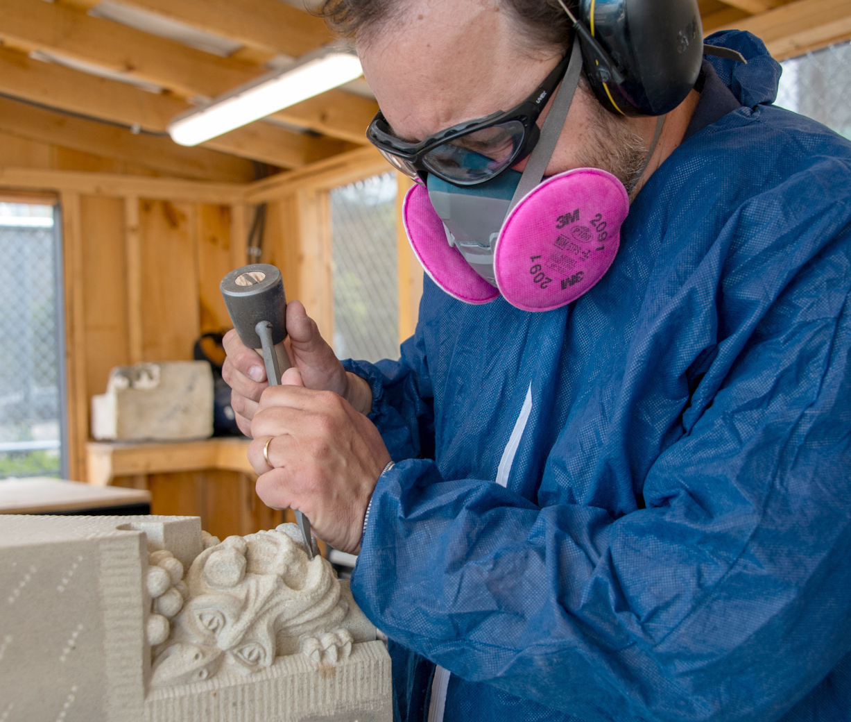 Sculptor George Moldovan adds finishing details to the sculpture.