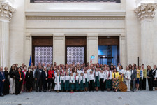 A group of people pose in the Senate of Canada Building. 