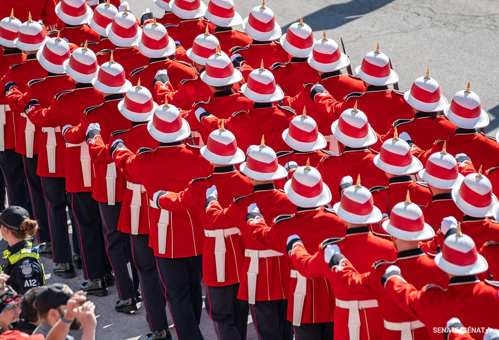 The Royal Canadian Regiment turns the streets of Ottawa red as they march to the Senate of Canada Building.