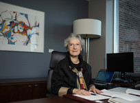 Senator Renée Dupuis sitting at her desk in her office on Parliament Hill.