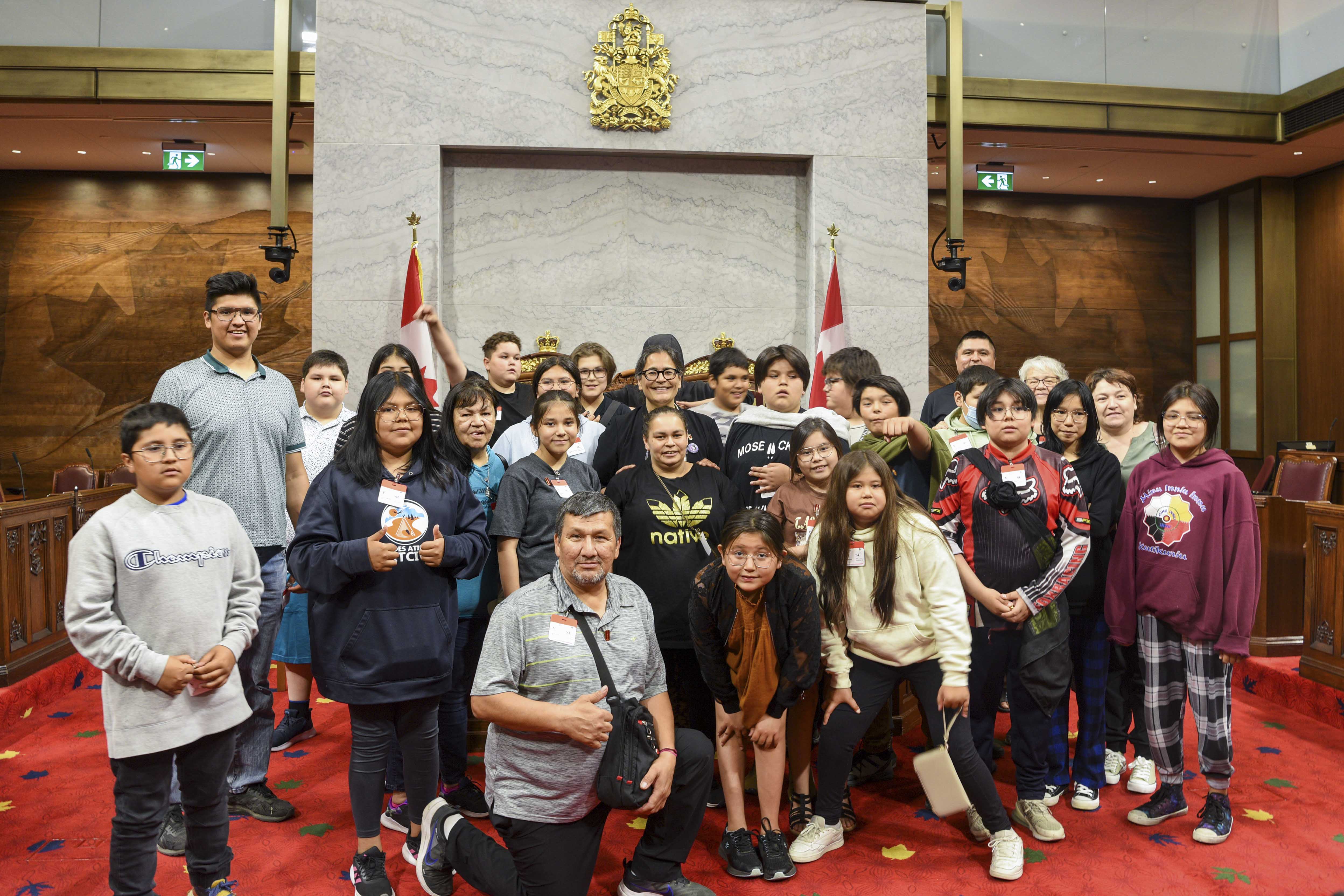 Friday, June 16, 2023 – Senator Michèle Audette, centre, third row; visit of the Red Chamber with Seskitin School students from the Wemotaci community (Quebec), organized by SENgage; Senate Chamber, Ottawa, Ontario
