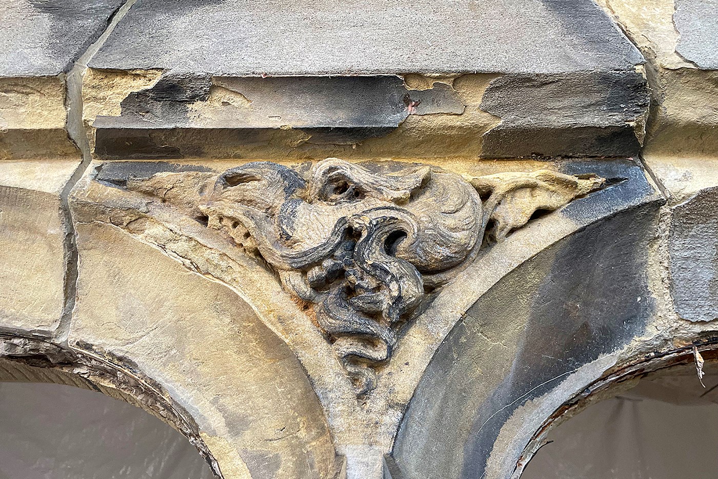The original sculpture, on the east face of Centre Block, shows signs of a century of damage from weather and chemical erosion. (Photo credit: Decorative Arts Studio)