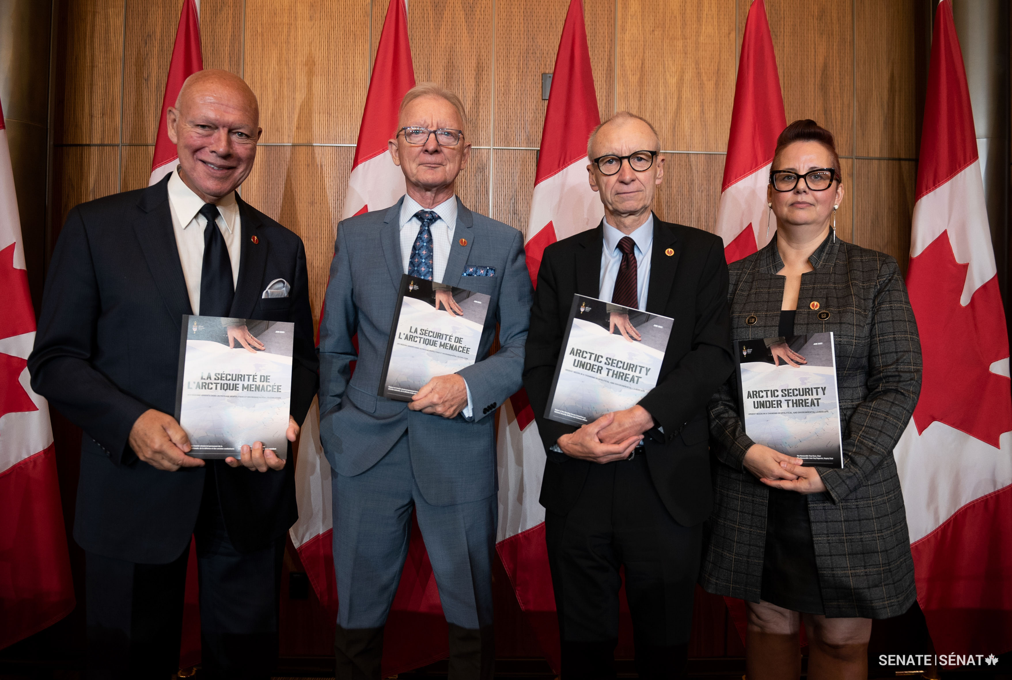 From left, senators Dagenais, Pierre-Hugues Boisvenu, Tony Dean and Dawn Anderson hold copies of a report on Arctic security in 2023.