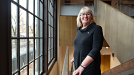 Senator Gwen Boniface stands on the stairs near the entrance to the Senate Chamber.