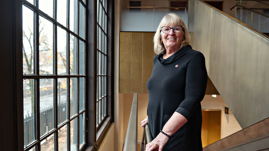 Senator Gwen Boniface stands on the stairs near the entrance to the Senate Chamber.